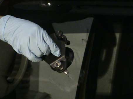 technician fixing auto glass crack
